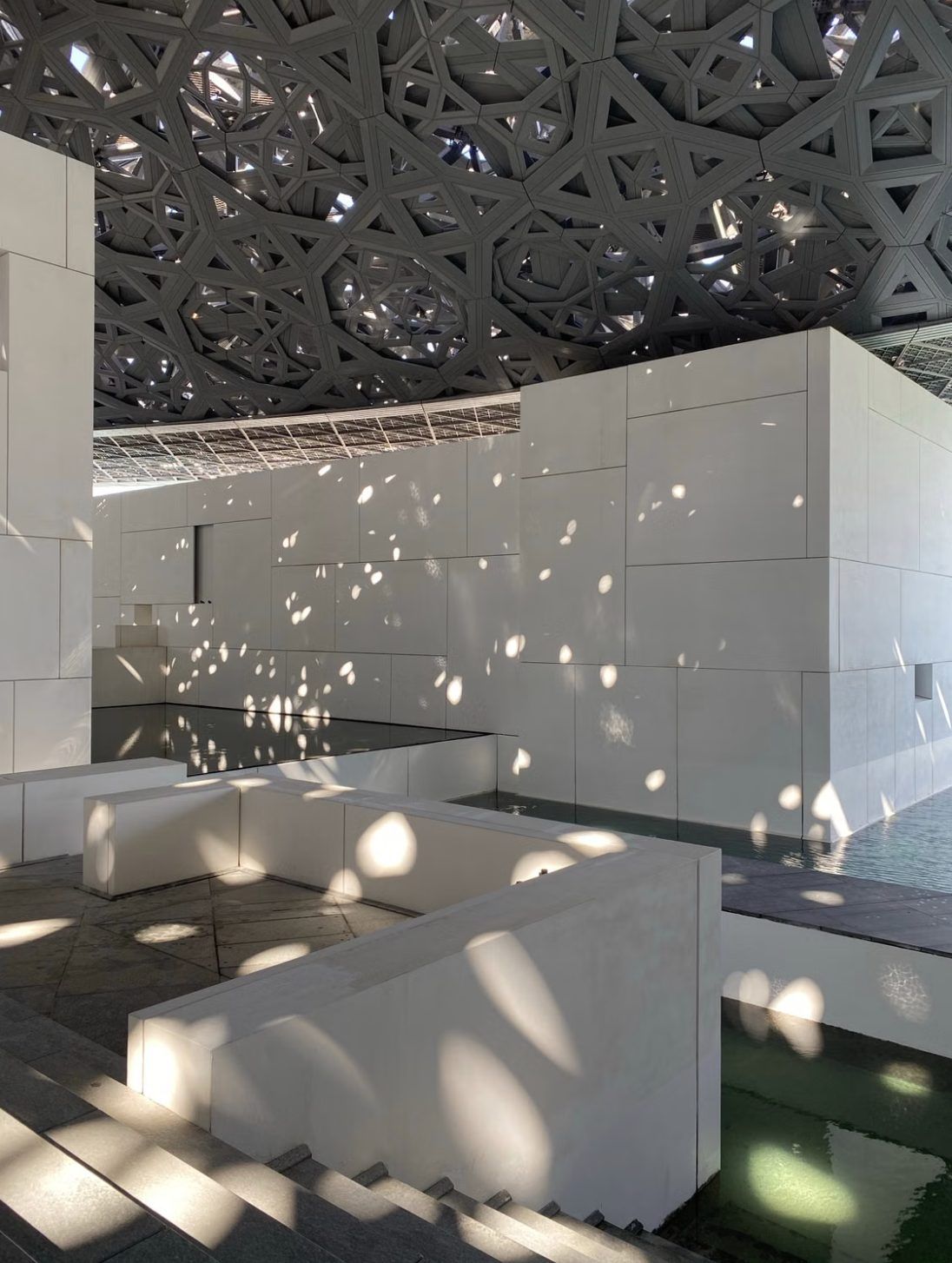 The perforated dome of Louvre Abu Dhabi casting its rain of light