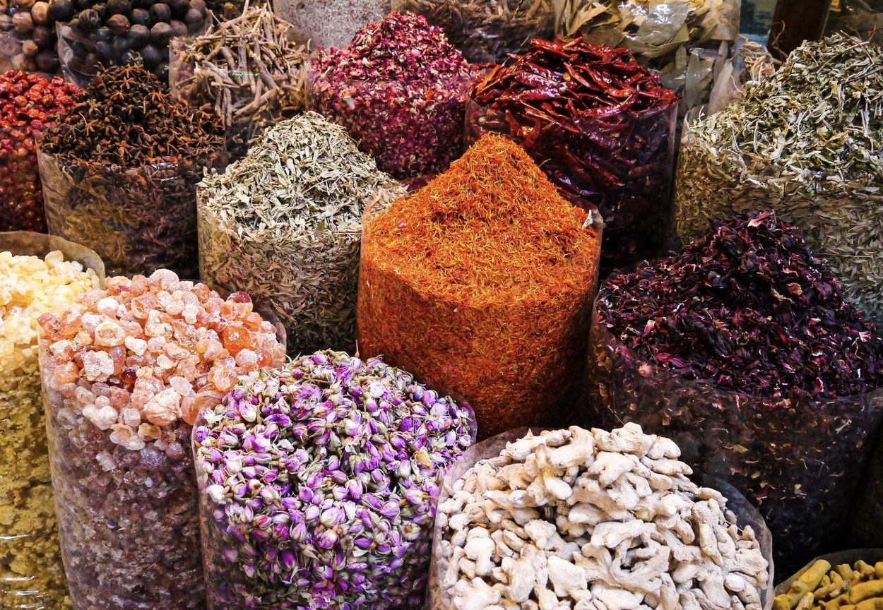 Open sacks of saffron, dried rosebuds and spices at the Dubai spice souk