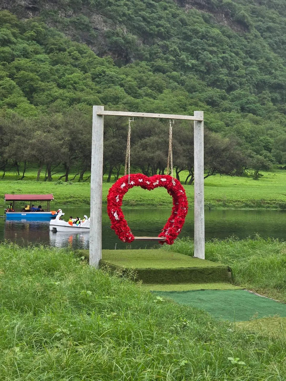 A flower-covered heart swing beside the lake at Wadi Darbat, Salalah